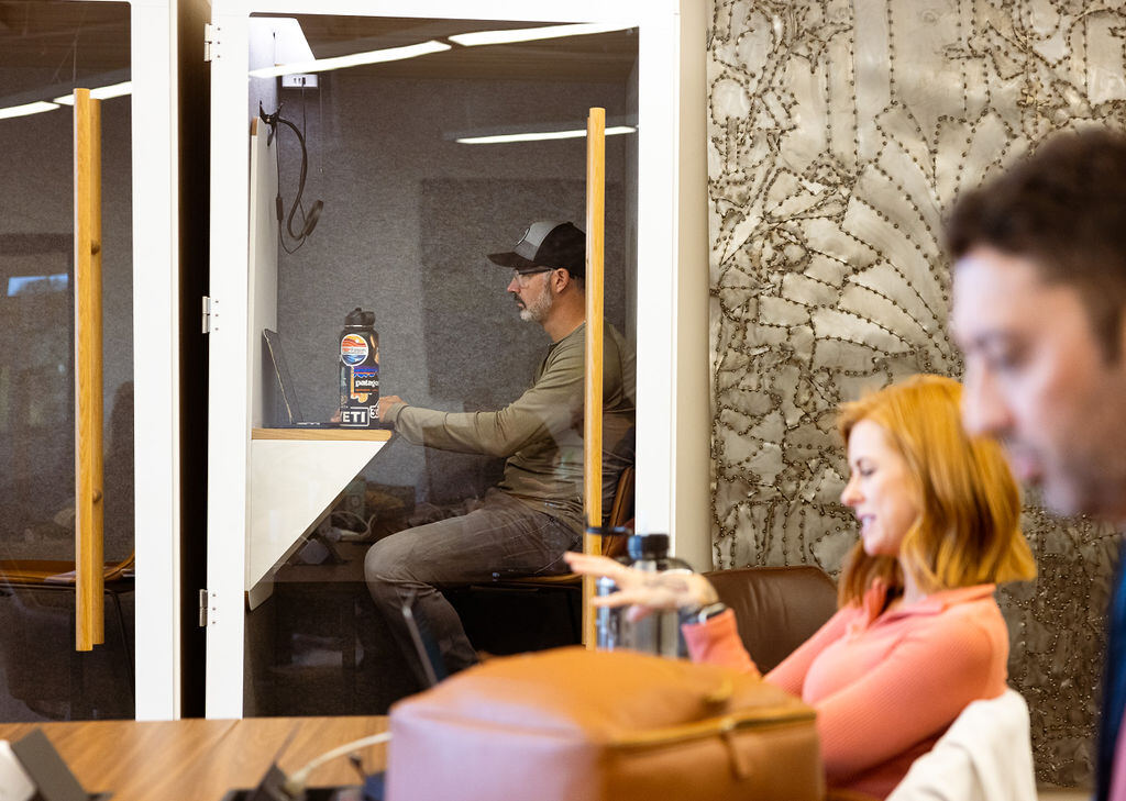 A member taking a call in a phone booth in Midtown at Granite City Workspaces in Folsom